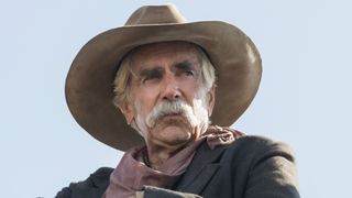 Sam Elliott wearing a cowboy hat and looking to his right in 1883.