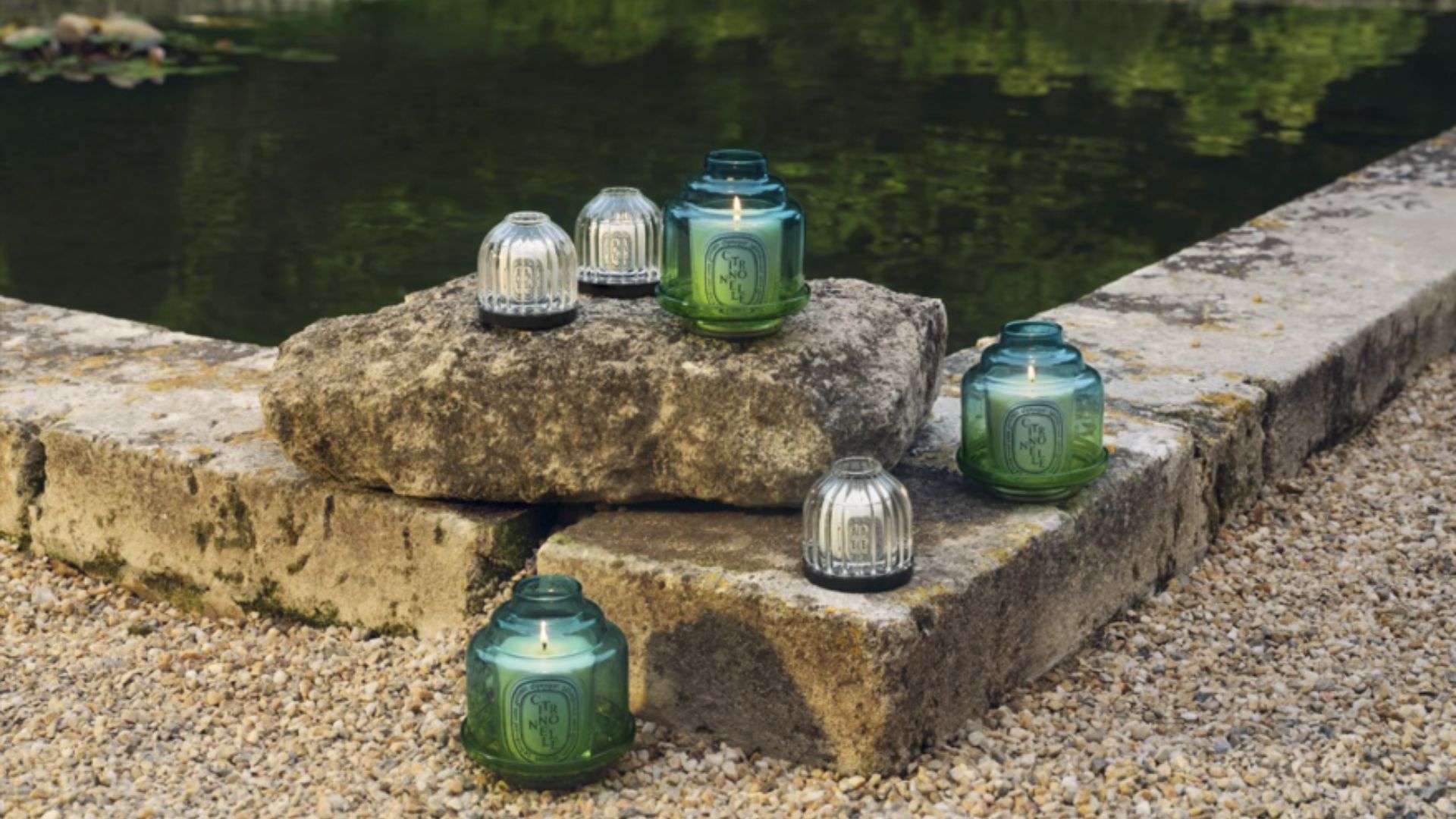 Diptyque Candle Collection beside some water