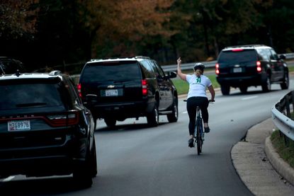 Juli Briskman flips off Donald Trump's motorcade.