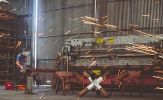 Jory Brigham welding in an industrial space
