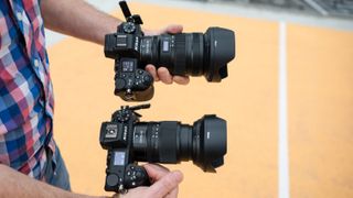 Nikon Z6 III camera next to a Nikon Z6 II camera each held in one hand