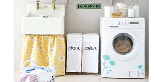 laundry room with butler sink with yellow sink curtain and washing machine