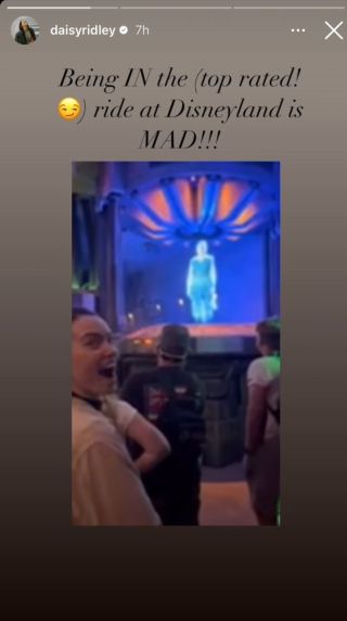 Daisy Ridley smiling after seeing herself as a hologram on Disney's Rise of the Resistance ride
