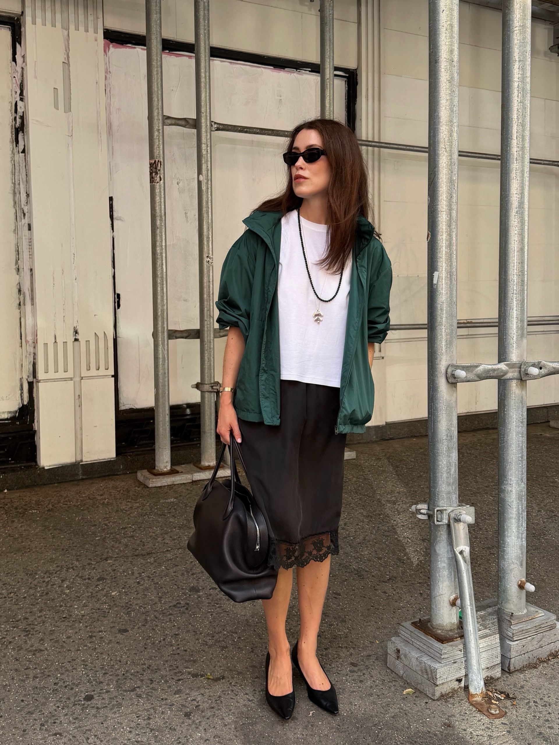 Woman in a windbreaker and lace skirt