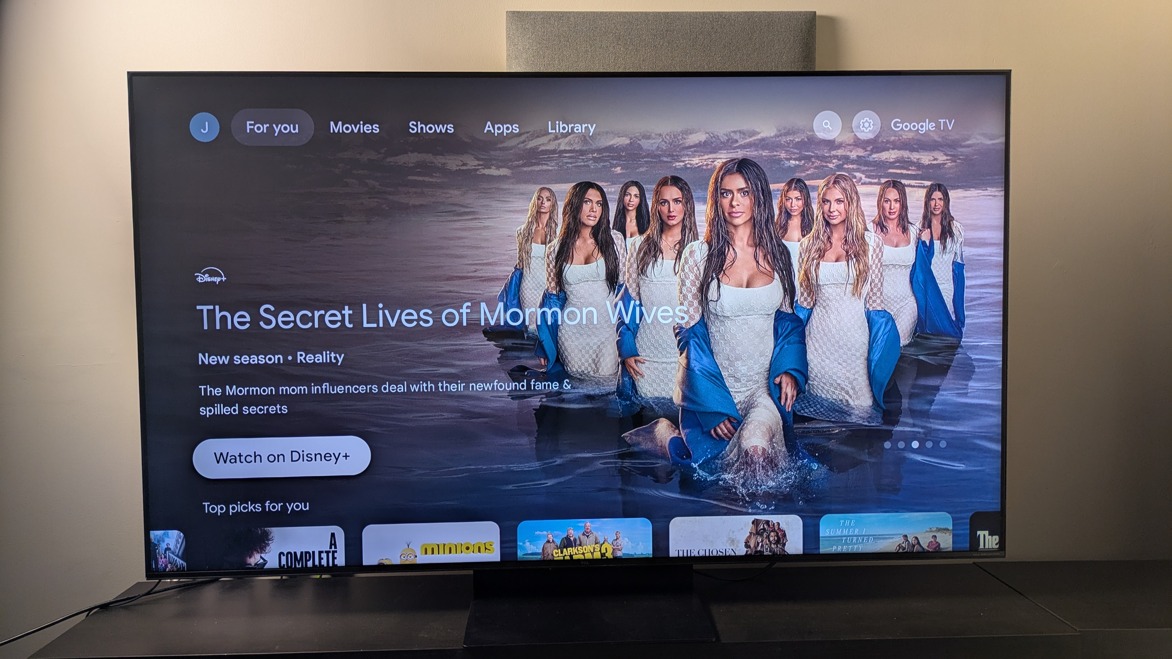 TCL C7K with Google TV home menu on screen