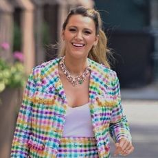 Blake Lively pulls off a rainbow tweed skirt set with a beaded Susan Alexandra bag.