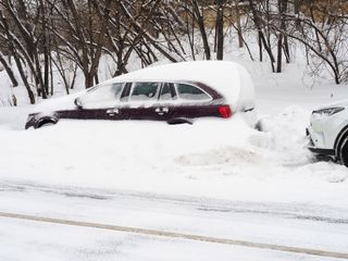 cars partially buried under snow