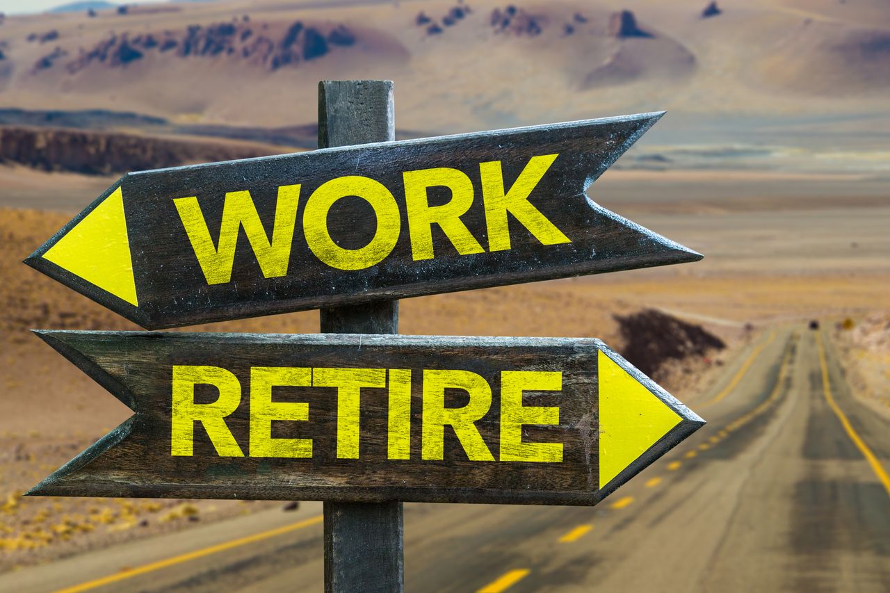 A road sign points in one direction with an arrow saying &quot;retirement&quot; and in the other direction with an arrow reading &quot;work.&quot;