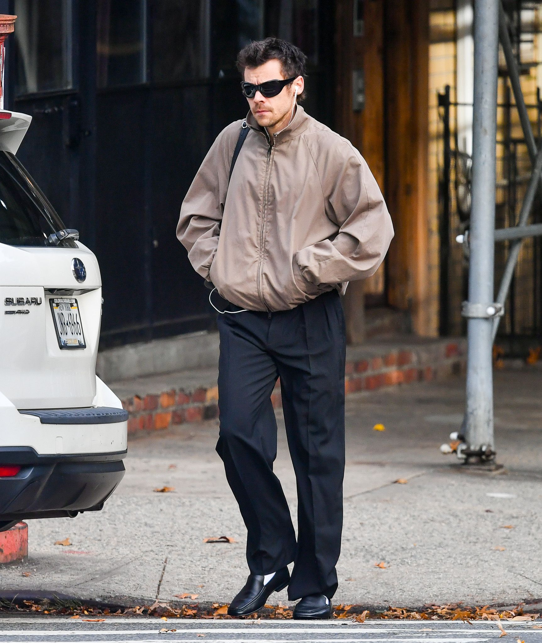 Harry Styles wore the funnel-neck jacket trend with trousers, just like his fiancée Zoë Kravitz