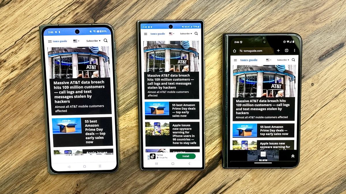 OnePlus Open vs Galaxy Z Fold 6 vs Pixel Fold on a table showing Tom's Guide website on cover display
