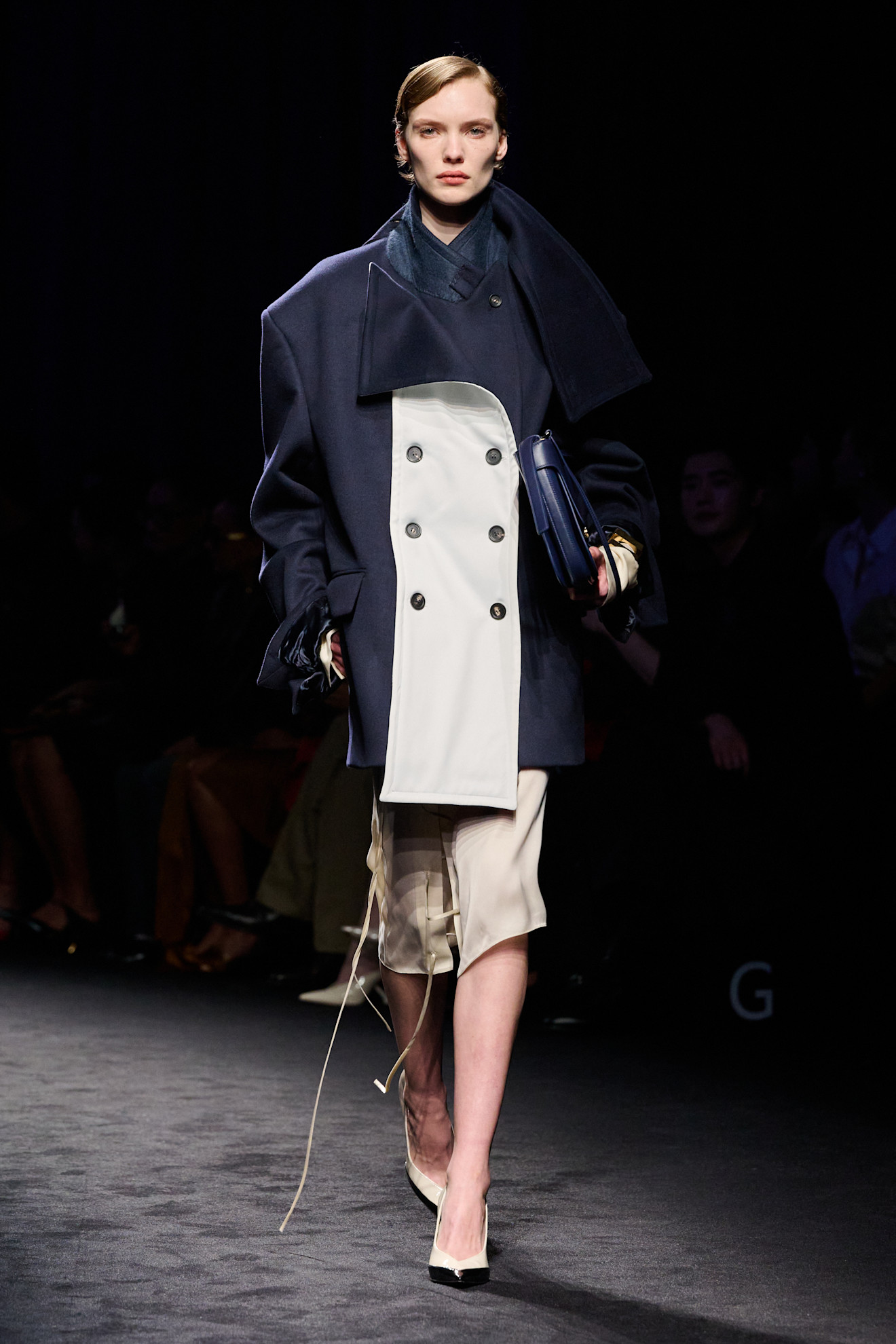 an image of a model wearing a coat from ferragamo f/w 26 show.