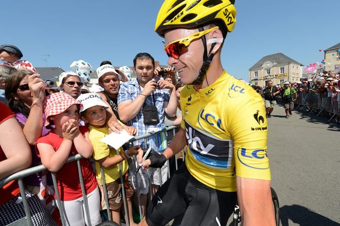 Chris Froome signs autographs at the start