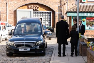 Sam Blakeman watches the hearse pull into the Street.