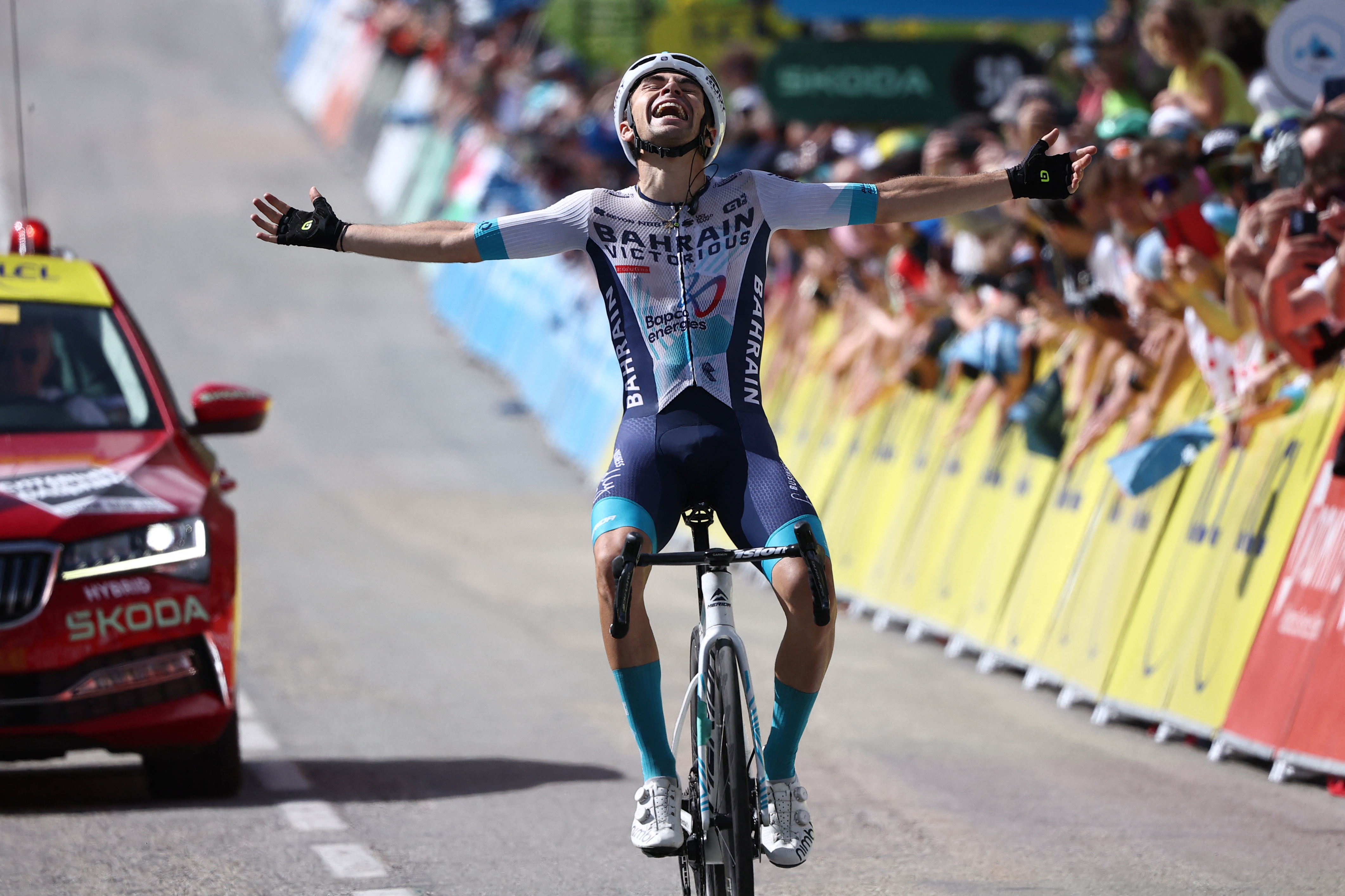 Bahrain Victorious's French rider Lenny Martinez celebrates as he crosses the finish line to win the 8th and final stage of the 77th edition of the Criterium du Dauphine cycling race, 133,3 km between Val-d'Arc and Val-Cenis - Plateau du Mont Cenis, on June 15, 2025. (Photo by Anne-Christine POUJOULAT / AFP) (Photo by ANNE-CHRISTINE POUJOULAT/AFP via Getty Images)