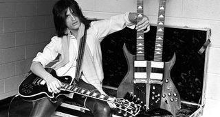 A black-and-white shot of Aerosmith&#039;s Joe Perry backstage with a B.C. Rich doubleneck and a Les Paul Custom