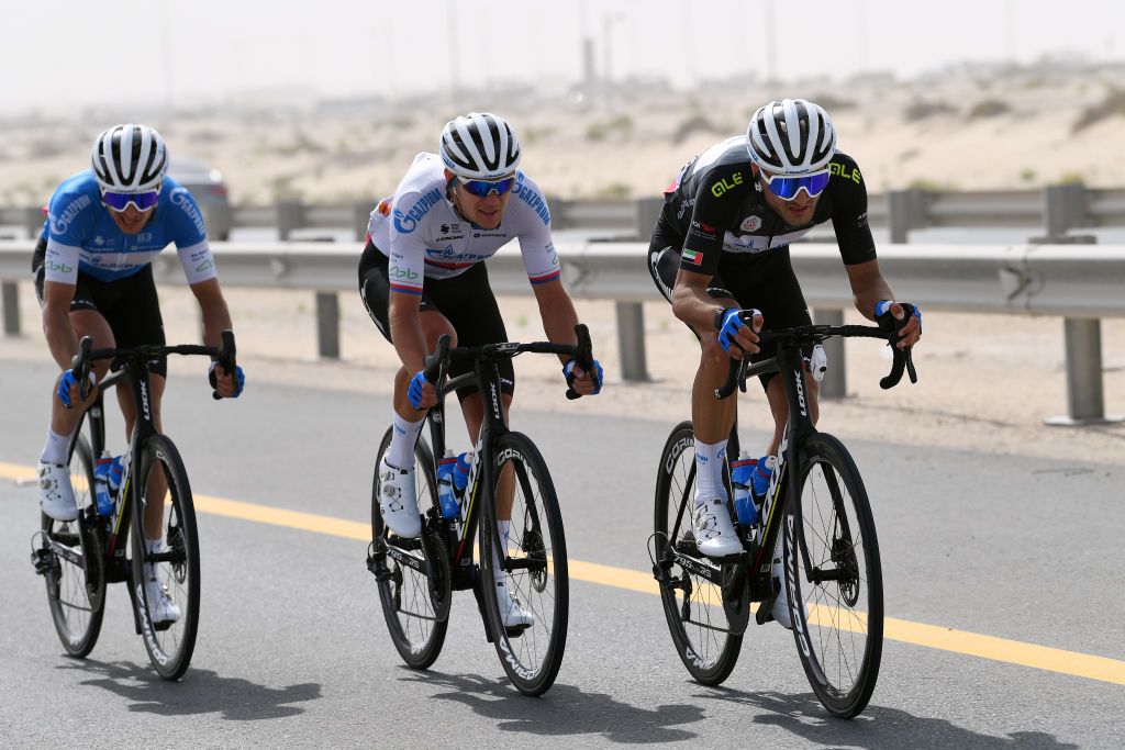 ABU DHABI UNITED ARAB EMIRATES FEBRUARY 21 LR Pavel Kochetkov of Russia Michael Kukrle of Czech Republic and Dmitrii Strakhov of Russia and Team Gazprom Rusvelo most aggressive jersey compete in the breakaway during the 4th UAE Tour 2022 Stage 2 a 176km stage from Hudayriyat Island to Abu Dhabi Breakwater UAETour WorldTour on February 21 2022 in Abu Dhabi United Arab Emirates Photo by Tim de WaeleGetty Images