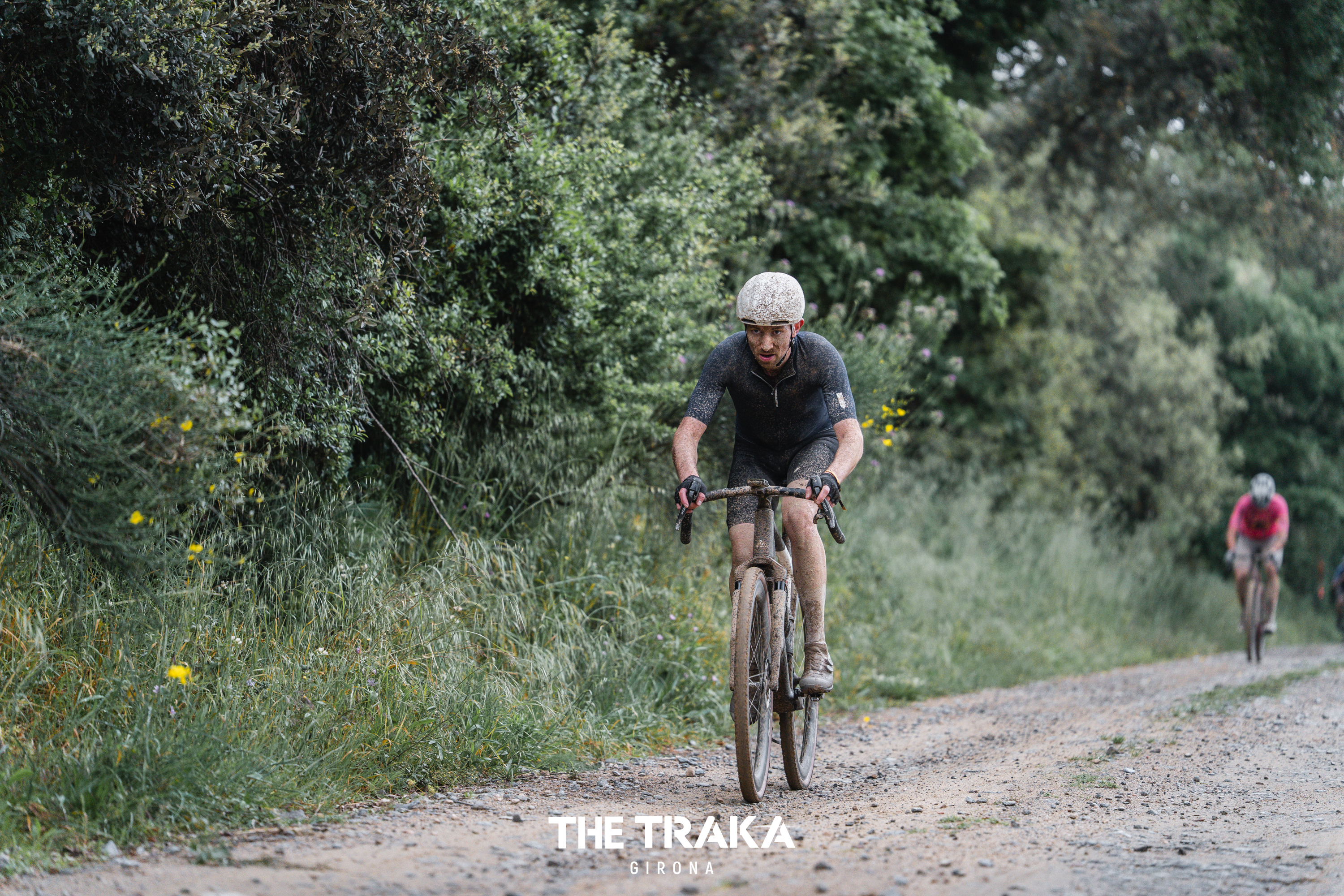 A male cyclist riding a gravel bike off road