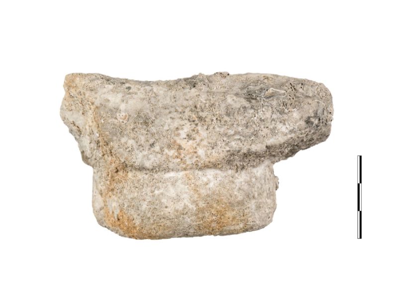 The remains of a white marble stone against a white background