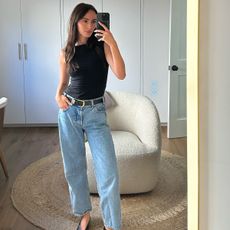 Livv Perez wearing a black tank top and jeans