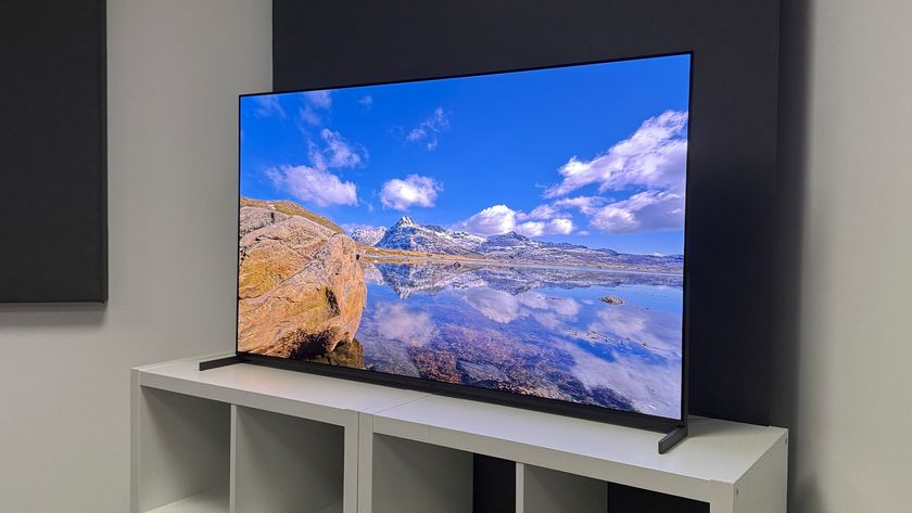 The 55-inch Sony Bravia 8 II QD-OLED TV photographed on a white table. On the screen is a nature documentary.