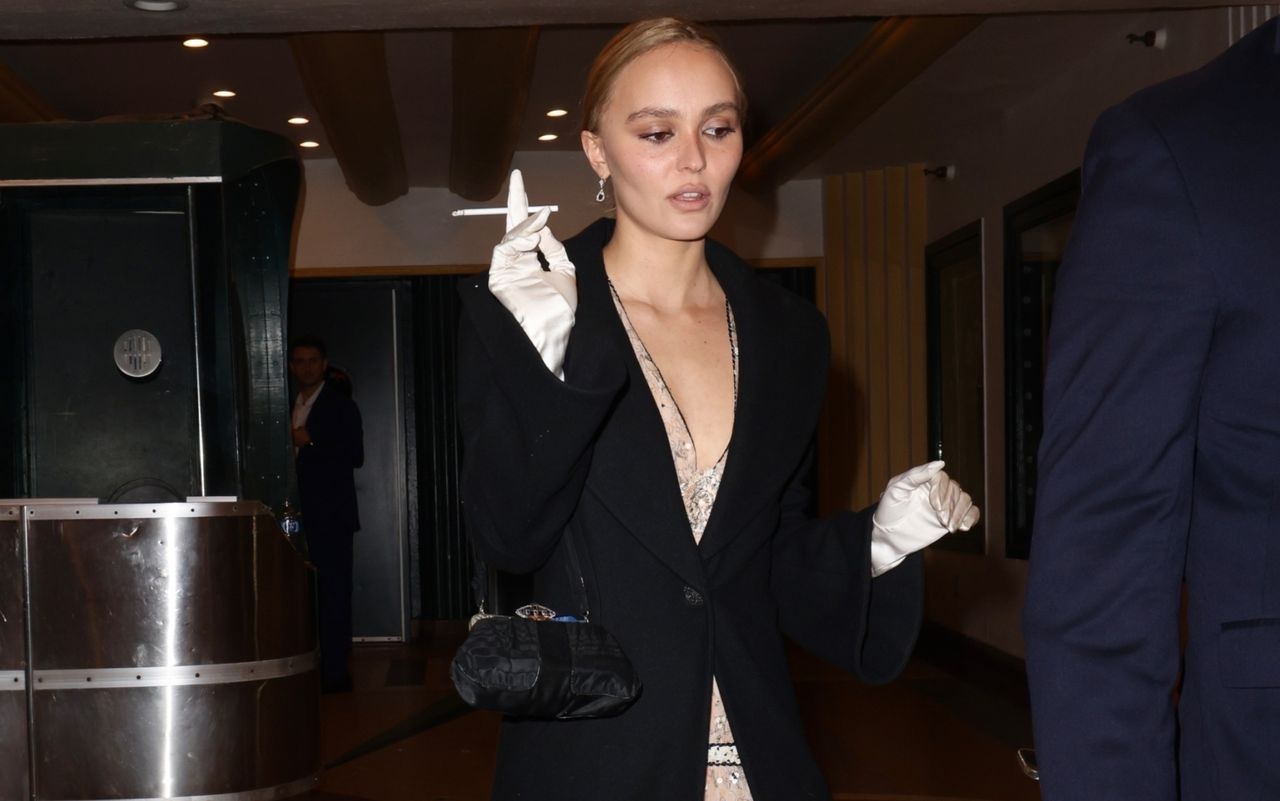 Lily-Rose Depp smoking a cigarette and wearing a vintage chanel dress with silk gloves