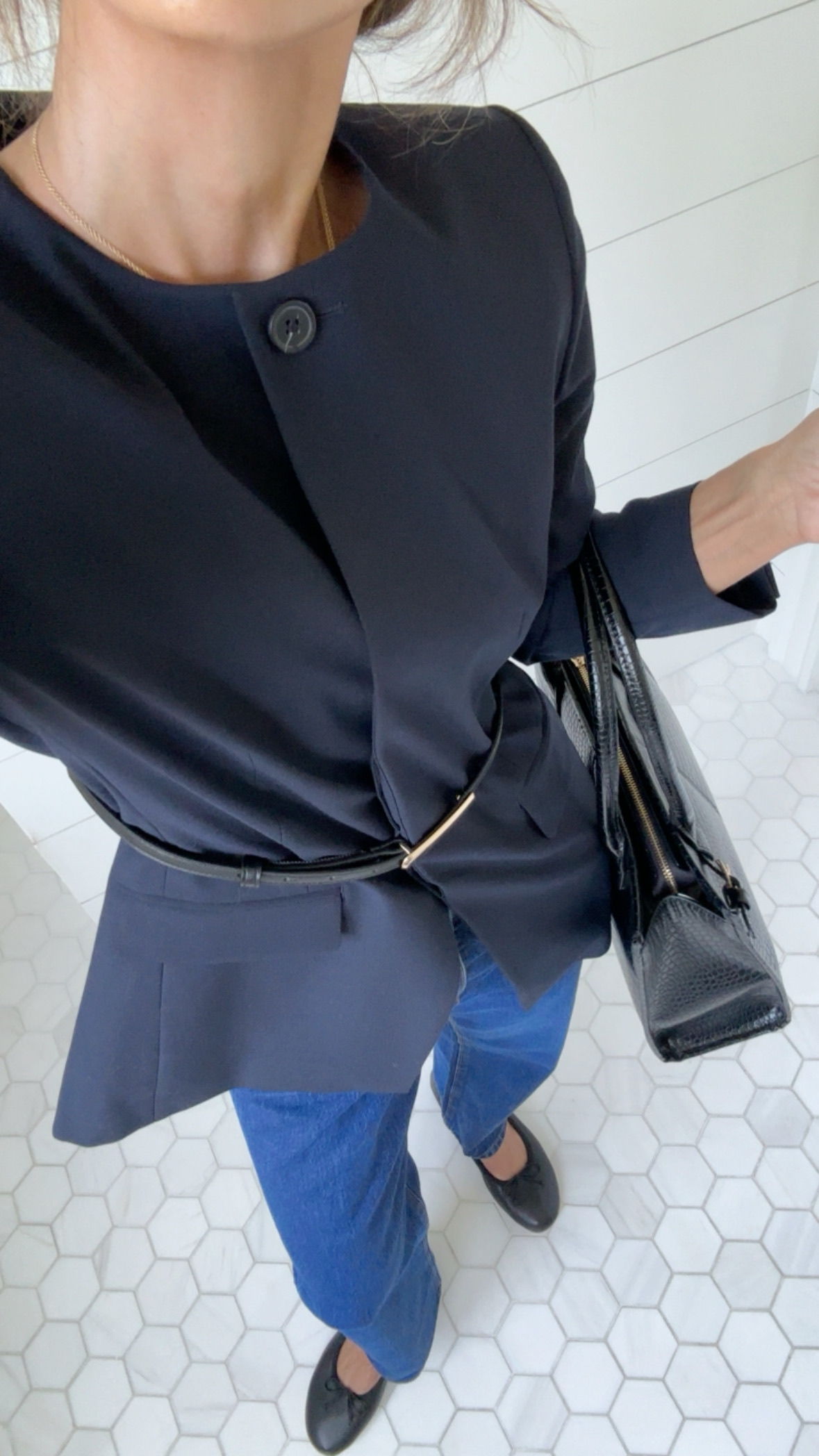 Larissa Mills wears a cinched jacket over jeans