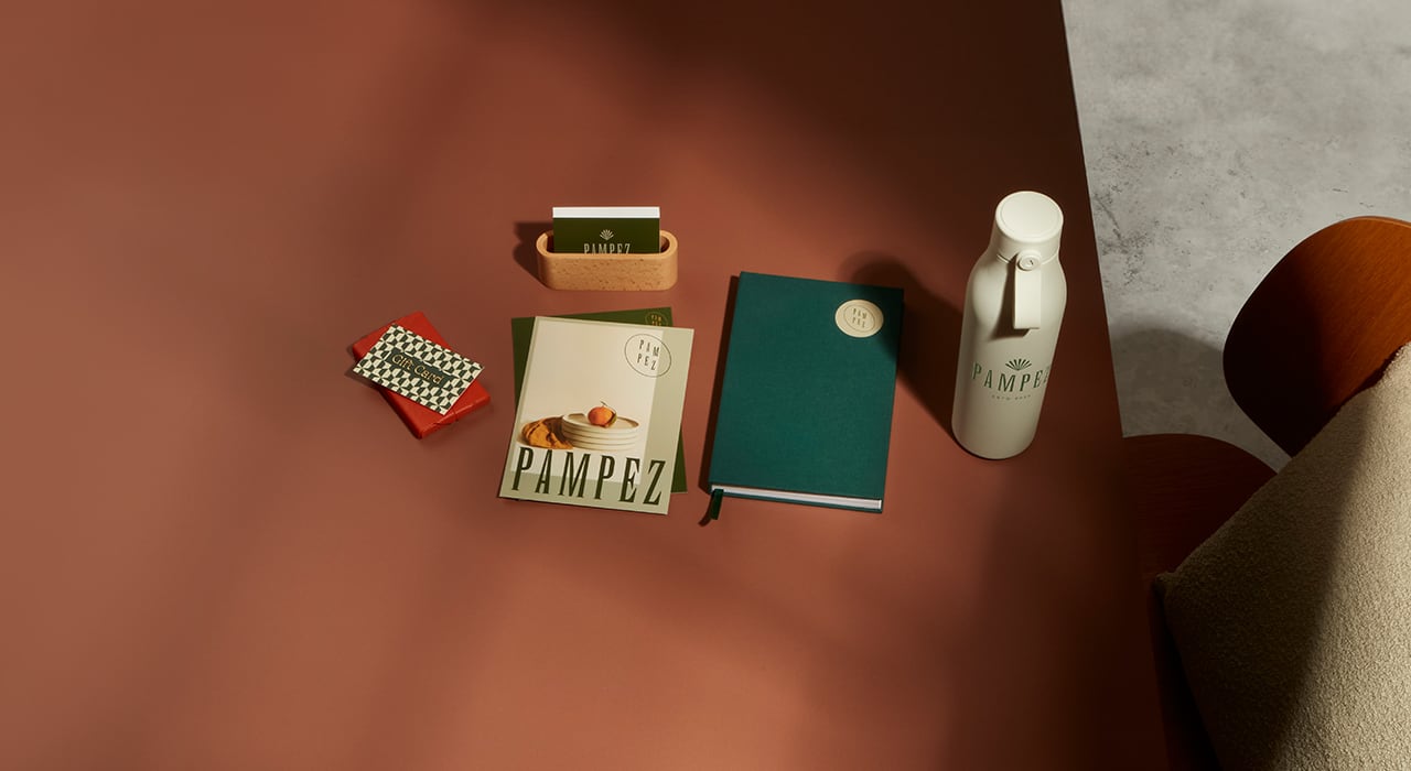 A spread of Moo printing products such as a notebook, business card and water botle