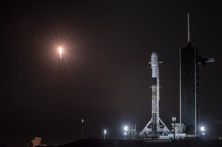 A SpaceX Falcon 9 rocket topped with Starlink satellites waits on the pad before its launch in February 2021.