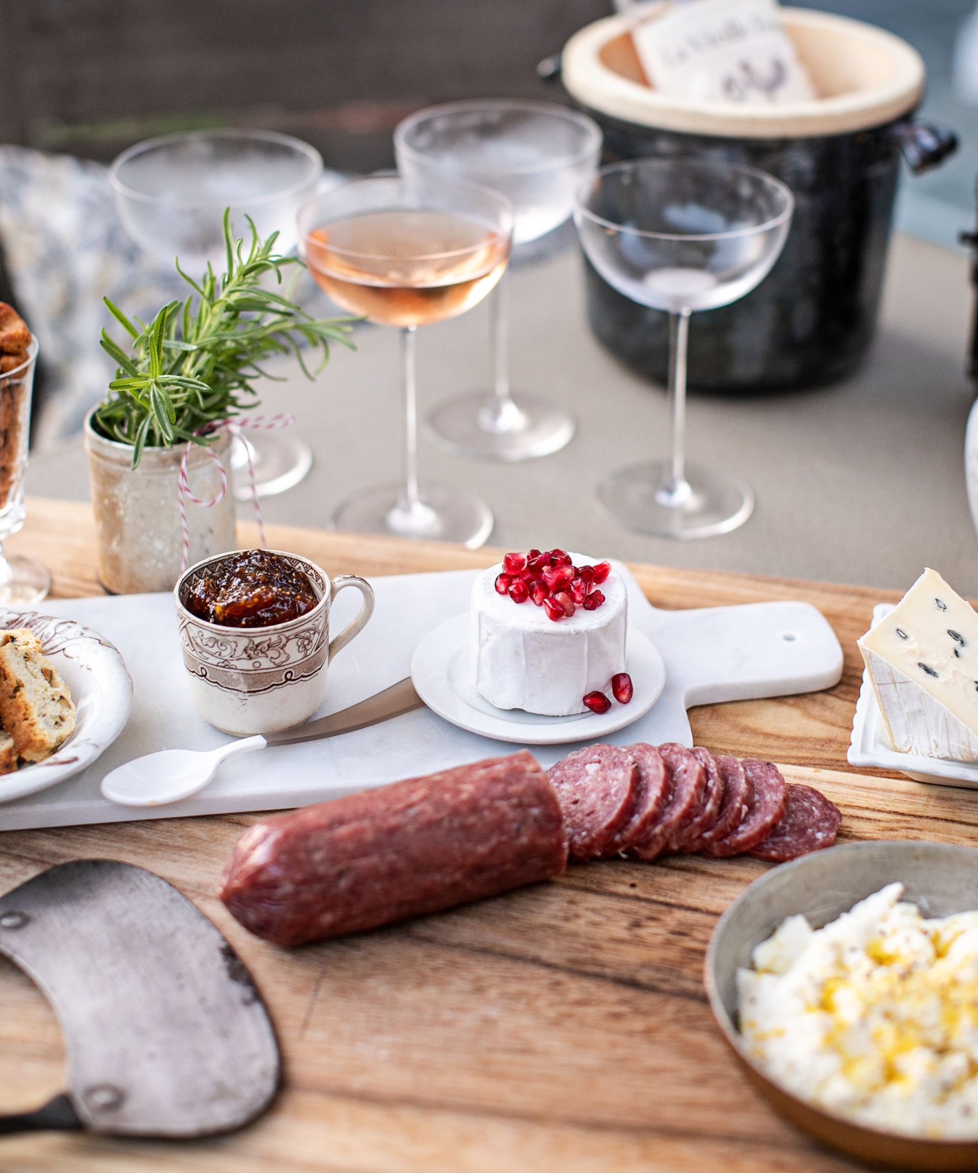 Table set with a platter of food and glasses of wine