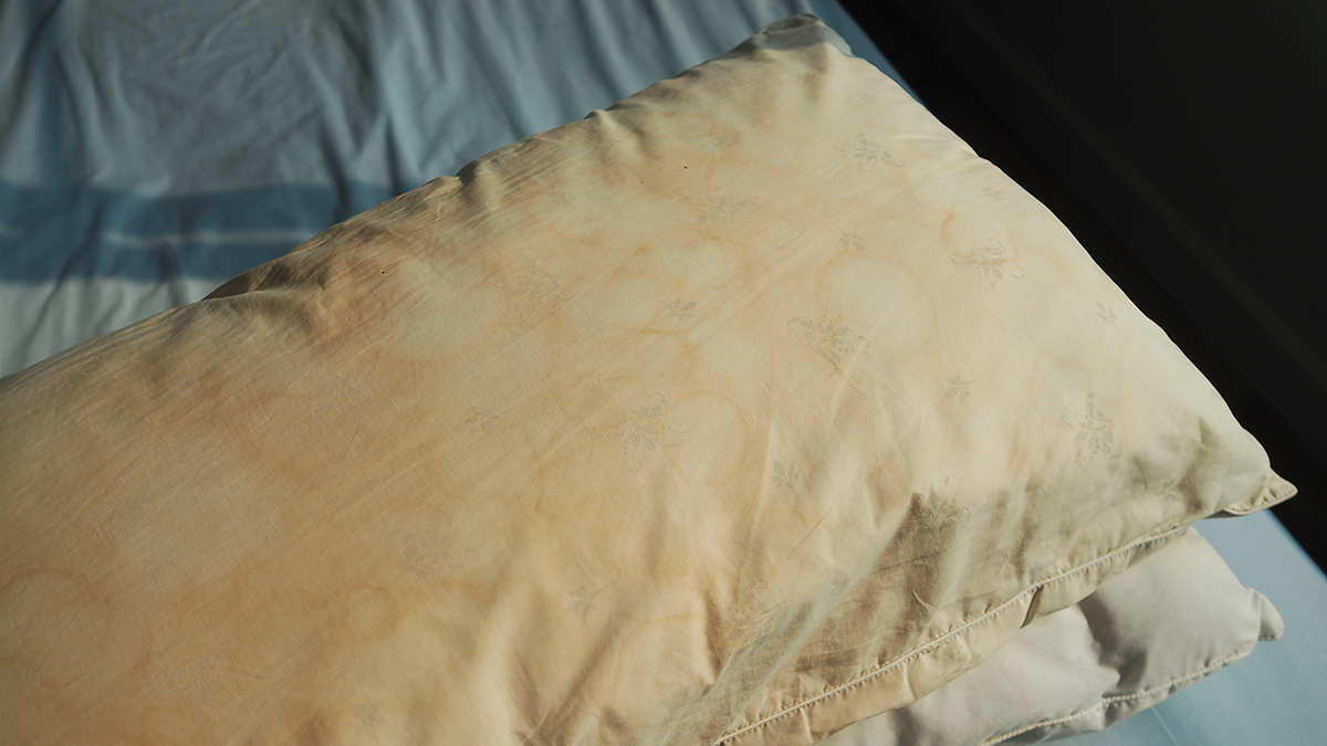 Two pillows with yellow staining