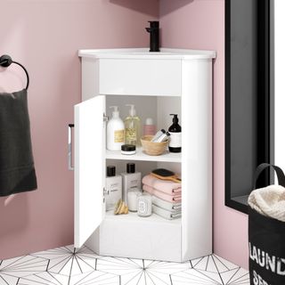 bathroom with pink wall and white cabinet