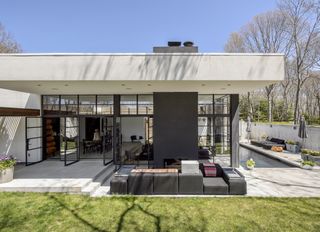 Exterior shot of a modern home with a small lawn in the backyard
