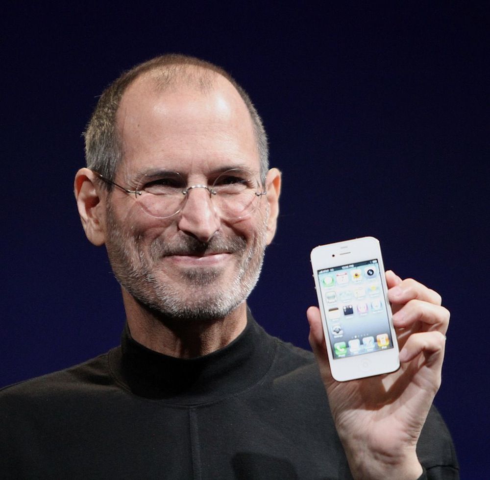 Steve Jobs shows off a white iPhone.