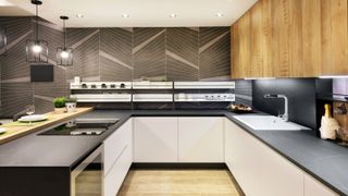 A narrow kitchen with a modern design and integrated appliances