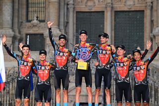 SANTIAGO DE COMPOSTELA SPAIN SEPTEMBER 05 Yukiya Arashiro of Japan Damiano Caruso of Italy Jack Haig of Australia Gino Mder of Switzerland Mark Padun of Ukraine Wouter Poels of Netherlands Jan Tratnik of Slovenia and Team Bahrain Victorious celebrates winning the best team on the podium ceremony in the Plaza del Obradoiro with the Cathedral in the background after the 76th Tour of Spain 2021 Stage 21 a 338 km Individual Time Trial stage from Padrn to Santiago de Compostela lavuelta LaVuelta21 ITT on September 05 2021 in Santiago de Compostela Spain Photo by Stuart FranklinGetty Images