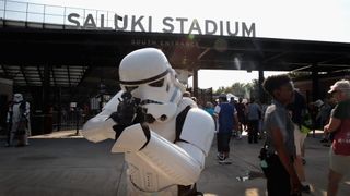 A person dressed as a Star Wars Stormtrooper poses as people arrive at Saluki Stadium on the campus of Southern Illinois University to watch the solar eclipse on August 21, 2017 in Carbondale, Illinois.