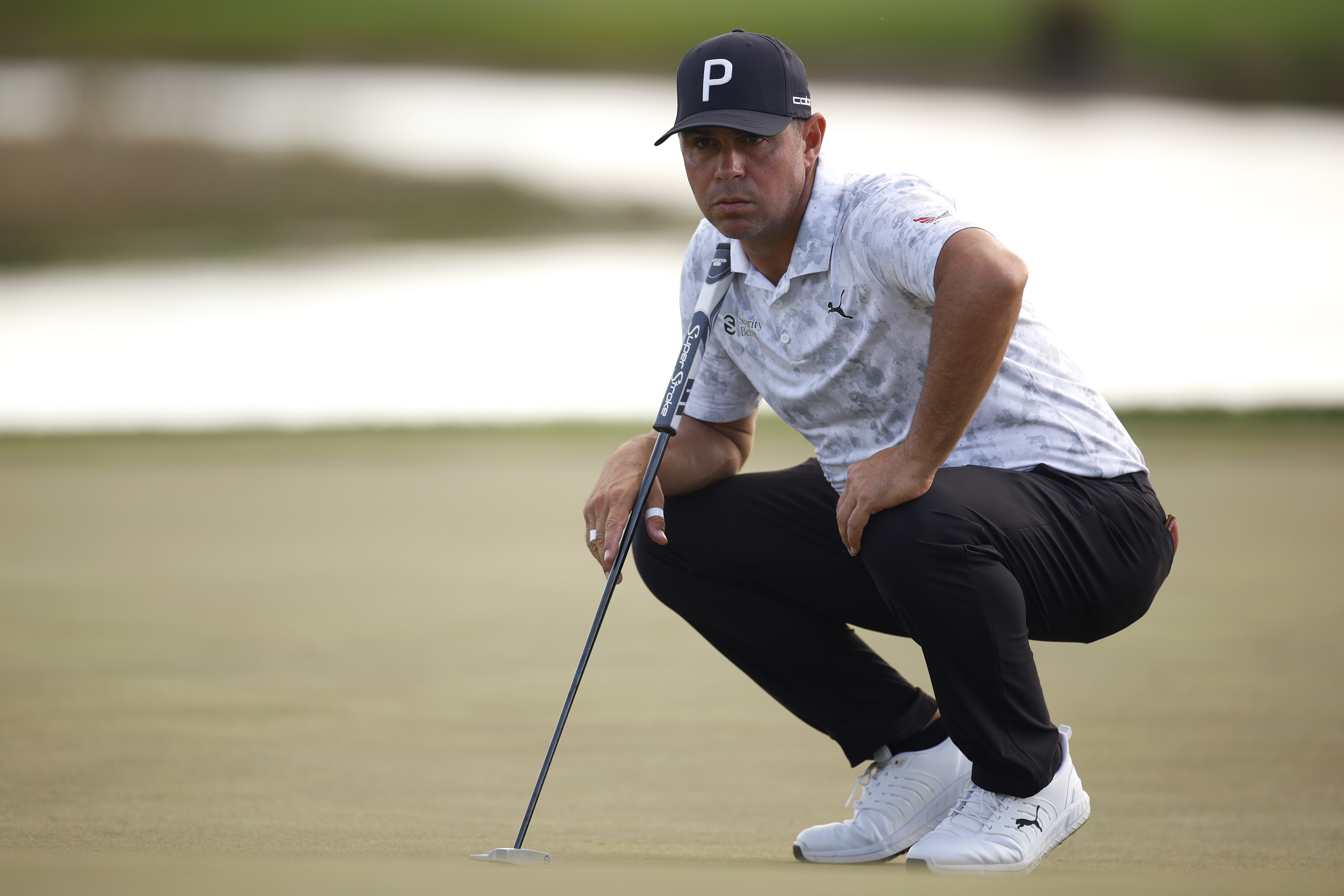 Gary Woodland lines up a putt