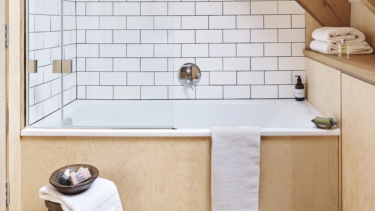 Bathroom with blonde wood and white metro wall tiling