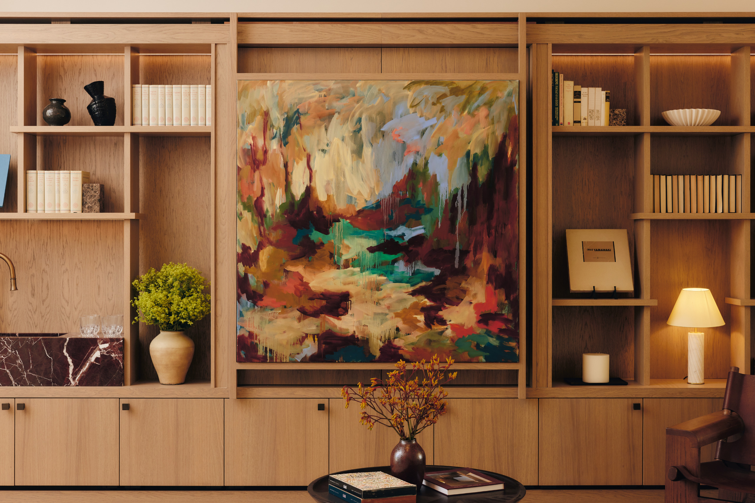 rear living room with shelving and artwork