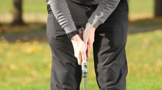 10 Reasons You Aren't Improving At Golf, golfer gripping the putter