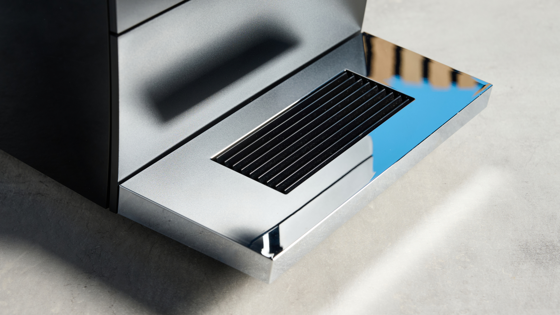 the jura ena 4 automatic coffee machine in piano black with a faceted water tank and bright screen