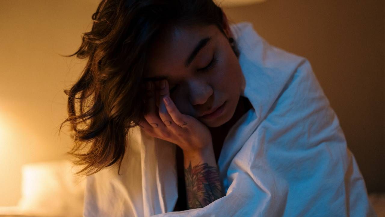 Woman feeling tired &amp; not able to sleep