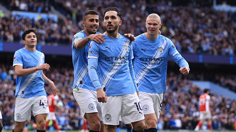 Rayan Cherki of Manchester City celebrates scoring their 1st goal during the Premier League match between Manchester City and Arsenal at Etihad Stadium. 