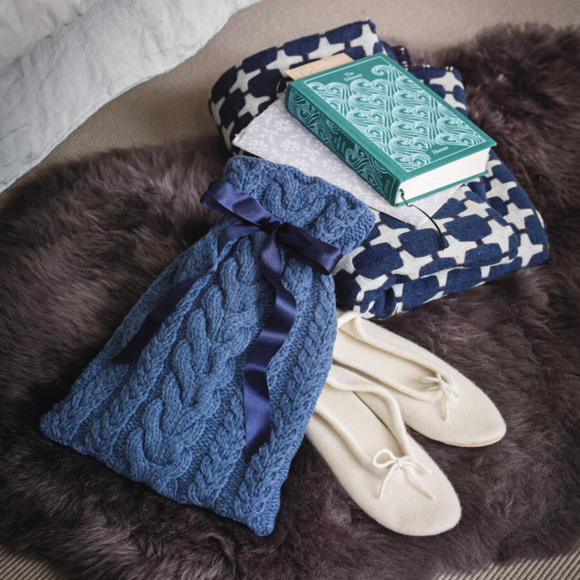 Sheepskin rug, hot water bottle, books, slippers