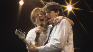 Bryan Adams and Keith Scott perform in 1985.