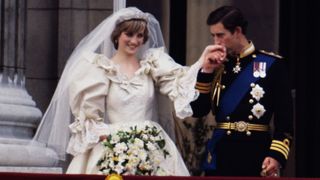 Princess Diana and Prince charles on their wedding day, charles in kissing her hand on their appearance to the public after the ceremony