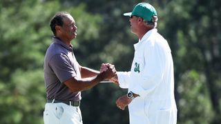 Tiger Woods embraces Lance Bennett after making the cut at The Masters