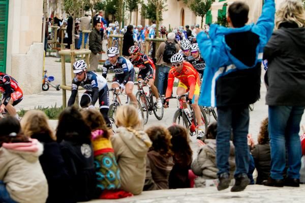 A school of children came out of class to watch the peloton zoom by.