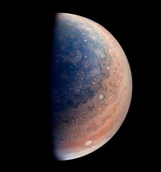 view of clouds swirling at jupiter's south pole