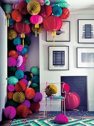 Paper lanterns up a wall and on to a ceiling